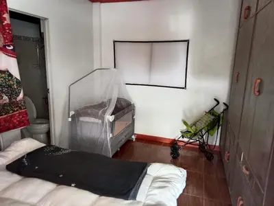 a room with a bed and a mirror on the wall at Your Little Resort, calm, secure in Manila