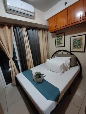 a bedroom with a bed with a plant on it at Darren Staycation in Manila