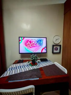 a computer monitor sitting on top of a desk at Darren Staycation in Manila