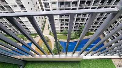 a view from the balcony of a apartment building at Cozy new studio walk to Mall of Asia with balcony in Sampong