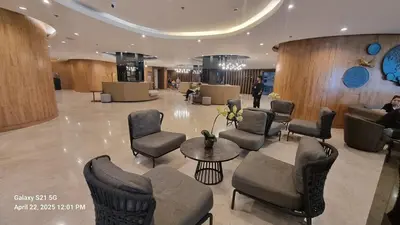 a lobby with chairs and a table in a building at Cozy new studio walk to Mall of Asia with balcony in Sampong