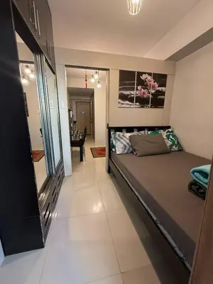 a bedroom with a large bed in a room at Zion Staycation at Sea Residences in Manila