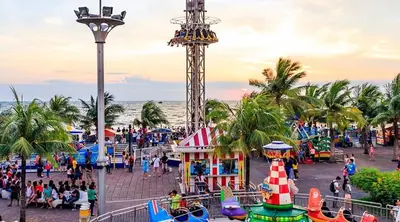 a crowd of people at a carnival on the beach at Shore 3 Residences Spacious & Spotless 1BR unit near airport MOA SMX in Manila