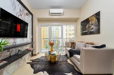 a living room with a couch and a tv at Bayshoreluxe in Manila