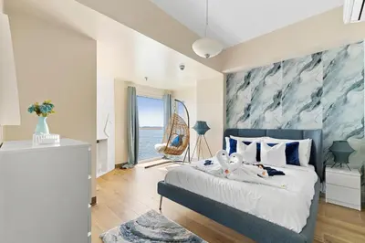 a bedroom with a bed with a blue and white wall at Bayshoreluxe in Manila