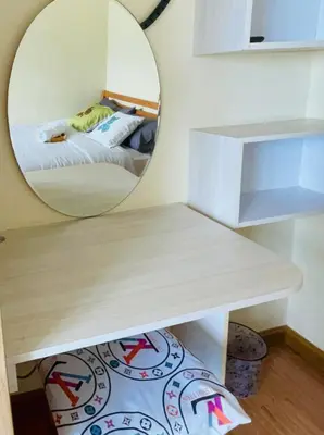 a bedroom with a circular mirror and a bed at Rhome Staycation by Azure St Tropez Tower Beach View Condo Unit in Manila