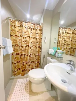 a bathroom with a toilet and a sink at Rhome Staycation by Azure St Tropez Tower Beach View Condo Unit in Manila