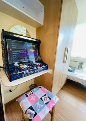 a room with a video game system on a shelf at Rhome Staycation by Azure St Tropez Tower Beach View Condo Unit in Manila