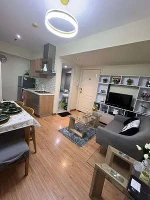 a living room with a couch and a table at Rhome Staycation by Azure St Tropez Tower Beach View Condo Unit in Manila