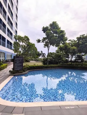a large swimming pool in front of a building at CHIC 1 BR in Air Residences in Manila