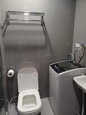 a small bathroom with a toilet and a sink at CHIC 1 BR in Air Residences in Manila