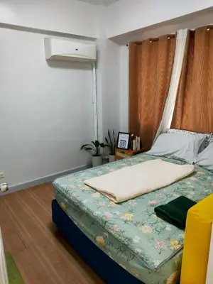 a bedroom with a bed with a canopy at BGC Condominium Near St Luke Fort Bonifacio Taguig in Manila