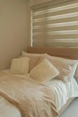 a bed with white sheets and pillows on it at The Metro Suite - 1BR Condo 36F with City View in Manila