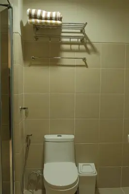 a bathroom with a toilet and a shower at The Metro Suite - 1BR Condo 36F with City View in Manila
