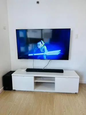 a white entertainment center with a flat screen tv at Avant at the Fort BGC with King Bed and Motorized Curtains & 65 in TV in Manila