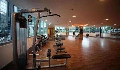 a gym with rows of exercise equipment in a building at Avant at the Fort BGC with King Bed and Motorized Curtains & 65 in TV in Manila