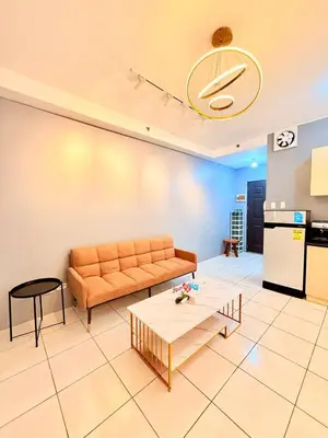 a living room with a couch and a table at Manila Korea Town Seaview and City View Staycation in Manila