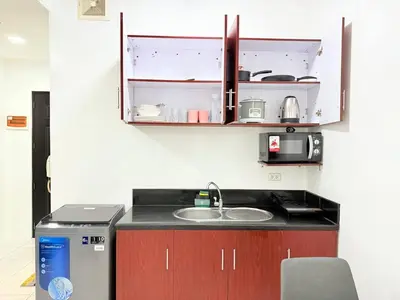 a kitchen with a sink and a microwave at Manila Korea Town Seaview and City View Staycation in Manila