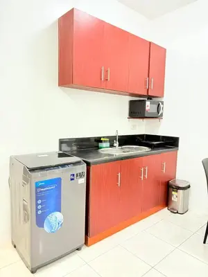 a kitchen with a sink and a dishwasher at Manila Korea Town Seaview and City View Staycation in Manila