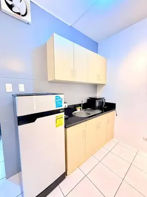 a small kitchen with a sink and a refrigerator at Manila Korea Town Seaview and City View Staycation in Manila