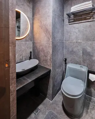 a bathroom with a toilet and a sink at Luxury Condo in the heart of BGC in Manila