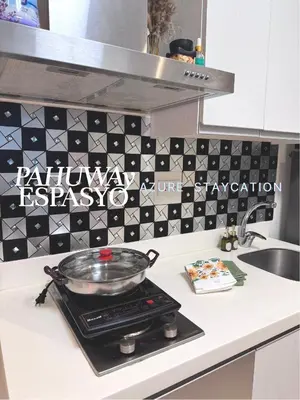 a pot on top of a stove in a kitchen at Azure Bahamas by Pahuway Espasyo in Manila