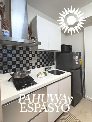 a kitchen with a sink and a refrigerator at Azure Bahamas by Pahuway Espasyo in Manila