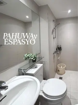 a bathroom with a white toilet and a sink at Azure Bahamas by Pahuway Espasyo in Manila