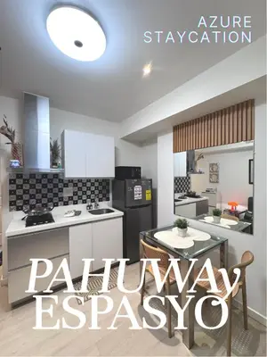 a kitchen with white appliances and a sign that readsprimary essex at Azure Bahamas by Pahuway Espasyo in Manila