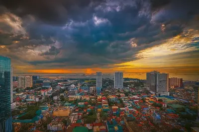 a view of a city with a cloudy sky at La Suitez 1421 l Sky Studio l 360 City l Sea View in Manila