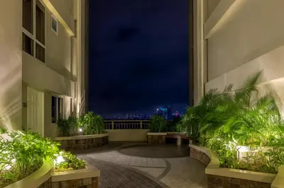 a room with a view of the city at night at La Suitez 1421 l Sky Studio l 360 City l Sea View in Manila