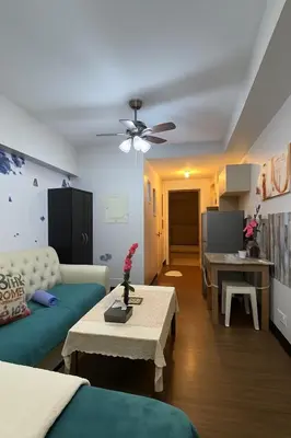 a living room with a couch and a table at La Suitez 1421 l Sky Studio l 360 City l Sea View in Manila