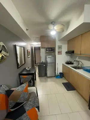 a small kitchen with a couch and a counter top at Makati City Antel Spa Residences 1615 in Manila