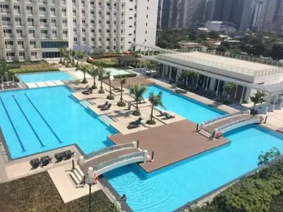 an overhead view of a large swimming pool in a city at Stylish Makati 2BR Condo with KTV and Awesome Pools! in Manila