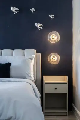 a bedroom with a bed and a nightstand with birds on the wall at BGC Designer Pad Near Shops Dining Nightlife in Manila
