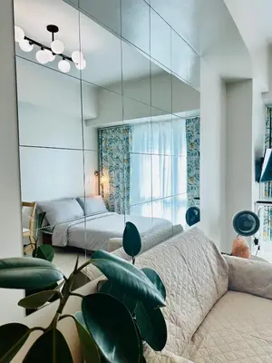 a bedroom with a couch and a mirror at Casa La Vista in Manila