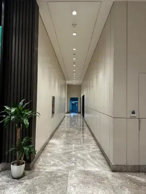 an empty hallway in a building with plants at Casa La Vista in Manila