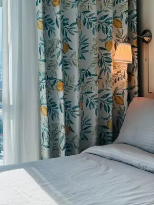 a bedroom with a bed and a curtain with oranges at Casa La Vista in Manila