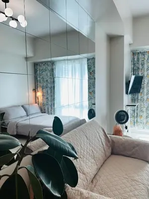 a living room with a couch and a mirror at Casa La Vista in Manila