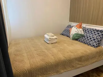 a bed with two pillows and two towels on it at The Residence Suite in Manila