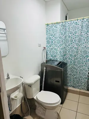 a bathroom with a toilet and a sink and a shower at Happy Stays E - 300mbps - 65
