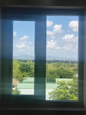 a window with a view of a green field at Happy Stays E - 300mbps - 65