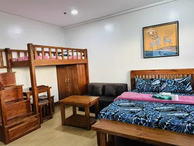 a bedroom with a bed and a bunk bed at Happy Stays E - 300mbps - 65