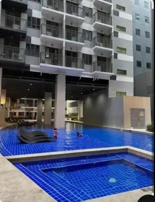 a large swimming pool in front of a building at S Residences Tower 1 Staycation in Manila