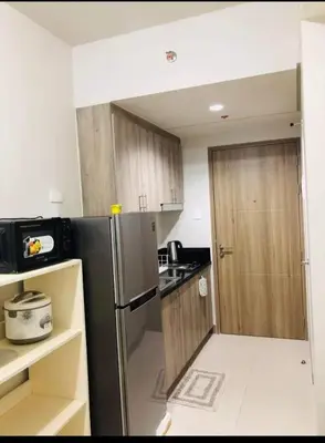 a kitchen with a stainless steel refrigerator and a door at S Residences Tower 1 Staycation in Manila
