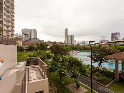 a view of a city from a balcony of a building at Family-Ready Skyline Retreat near BGC with Free Parking in Manila