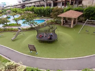 an outdoor playground with a slide and a swing at Family-Ready Skyline Retreat near BGC with Free Parking in Manila