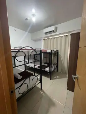 a room with two bunk beds in a room at 1158-2Br 6beds 2 extra mattress 2-sofa in Manila