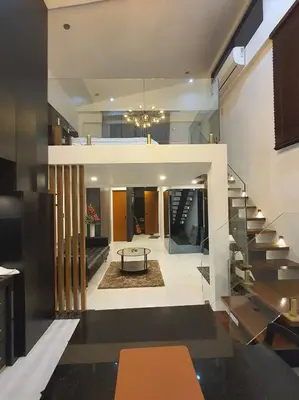 a living room with a staircase and a table at Casa Prinza Luxury Suite in Teresa