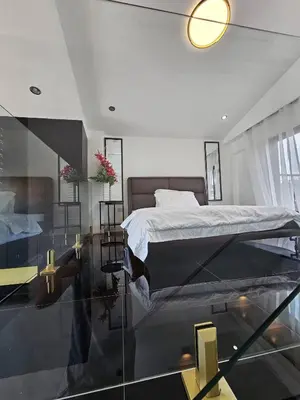 a bedroom with a bed and a glass floor at Casa Prinza Luxury Suite in Teresa